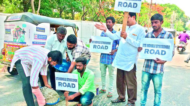 A group of citizens of fill a pothole on the East Marredpally road and rename it KTR-Nirmala Sitharaman Road in order to goad officials into action. (Photo: DC)