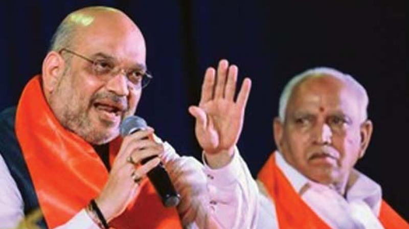 A file photo of state BJP chief B.S. Yeddyurappa with party president Amit Shah.