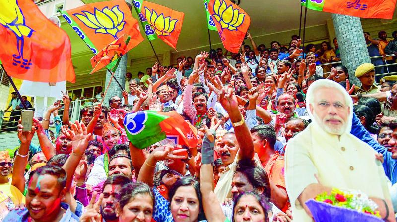 BJP workers celebrate outside the party office in Bengaluru on Tuesday.  (Photo: PTI)