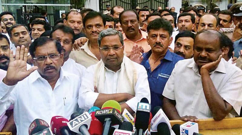 JD(S) leader HD Kumaraswamy with Congress leaders Siddaramaiah, Dr. G. Parameshwar and D.K. Shivakumar at the Raj Bhavan in Bengaluru on Tuesday. (Photo: KPN)