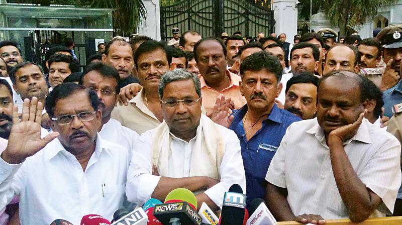 JD(S) leader HD Kumaraswamy with Congress leaders Siddaramaiah, Dr. G. Parameshwar and D.K. Shivakumar at the Raj Bhavan in Bengaluru on Tuesday. (Photo: KPN)