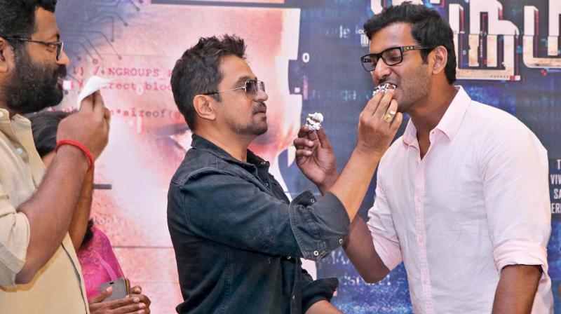 Vishal shares a warm moment with Arjun at IT success meet  Mithran looks.