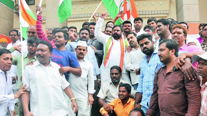 Congress workers celebrate at Gandhi Bhavan after hearing the news of  BS Yeddyurappa quiting as Karnataka Chief Minister before a trust vote.