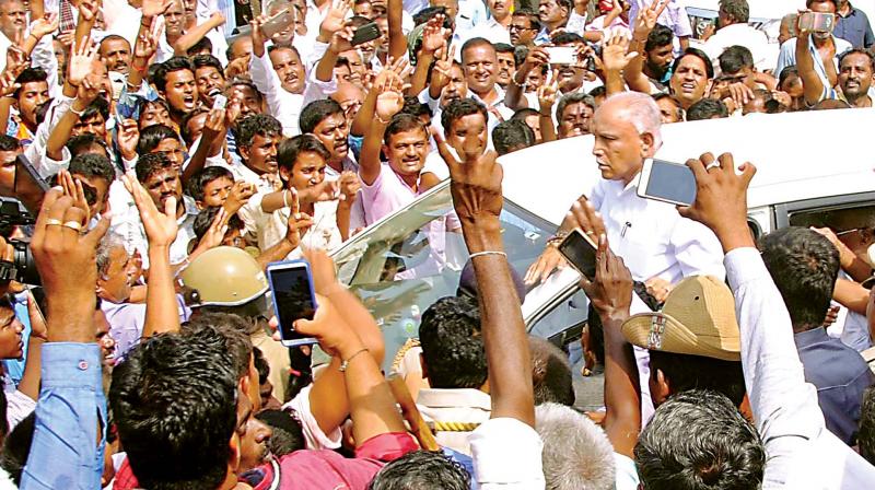 BJP workers greet former CM B.S. Yeddyurappa during his visit to Santebennur on Monday. (Photo: KPN)