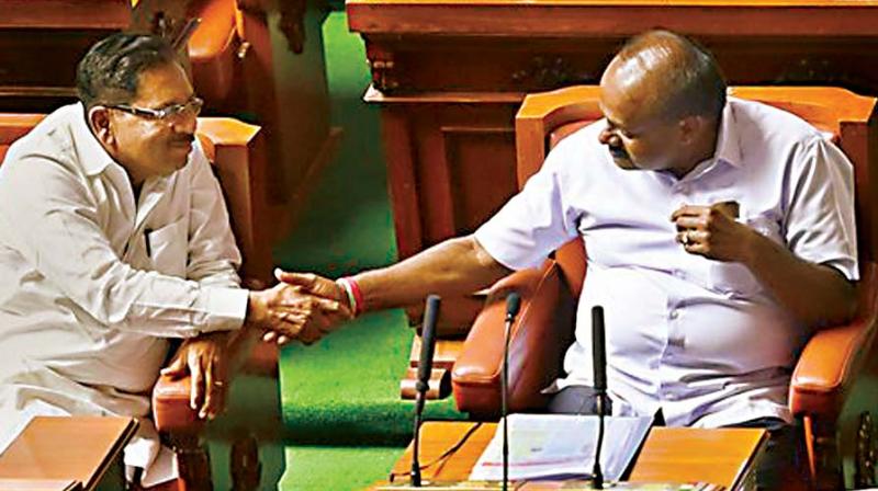 CM H.D. Kumaraswamy and Dy CM G. Parameshwar greet each other after their coalition government won the trust vote. (Photo: PTI)