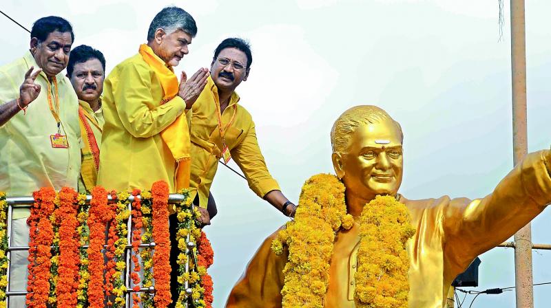 AP Chief Minister N. Chandrababu Naidu garlands the statue of party founder N.T. Rama Rao at Patamata centre before going to Mahanadu in Vijayawada on Monday. (Photo: DC)