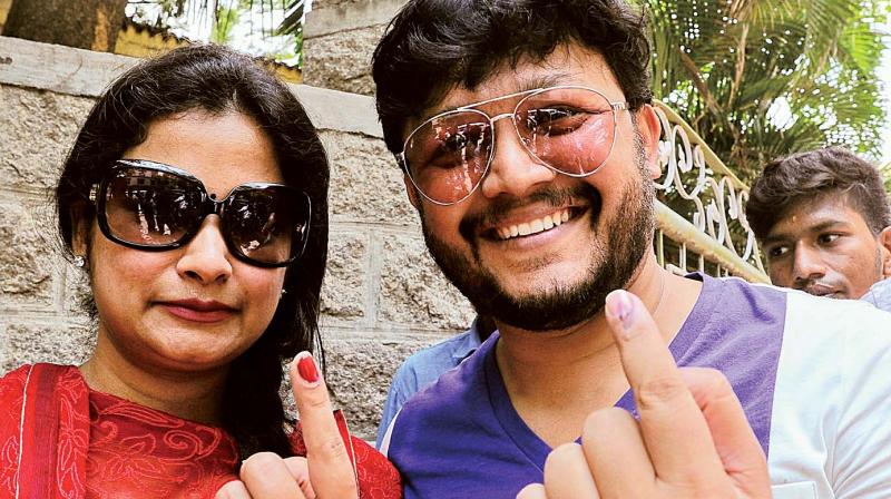 Actor Ganesh with his wife Shilpa after casting their vote in RR Nagar on Monday. (Photo: DC)