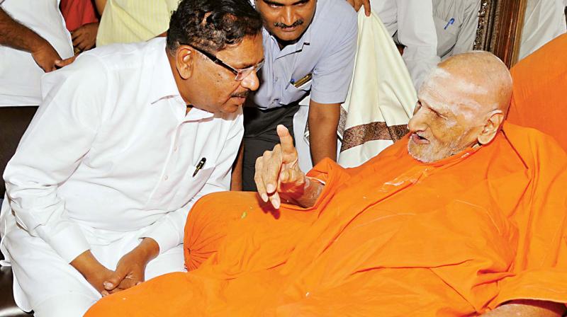 Dy CM G. Parameshwar calls on Sri Shivakumara Swami at Siddaganga Math in Tumakuru on Tuesday.