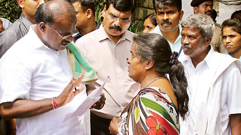CM H.D. Kumaraswamy speaks to a woman during the Janata Darshan programme in Bengaluru on Tuesday.
