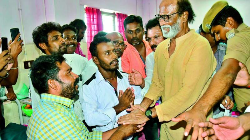 Rajinikanth with an injured person at Thoothukudi government medical college hospital on Wednesday.