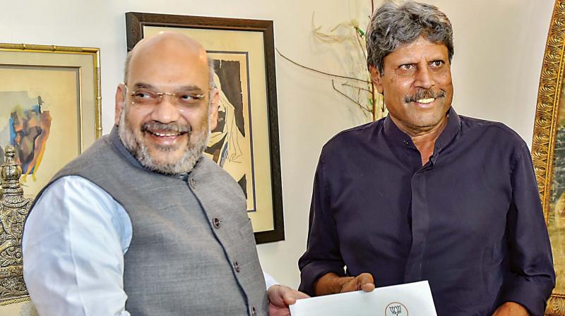 BJP chief  Amit Shah meets former cricketer  Kapil Dev during his Sampark for Samarthan campaign to generate awareness about the NDA governments achievements, in New Delhi on Friday. (Photo: PTI)