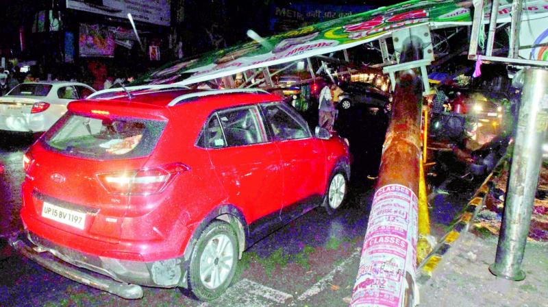 A hoarding collapses during a thunderstorm, in Meerut on Friday night. (Photo: PTI)