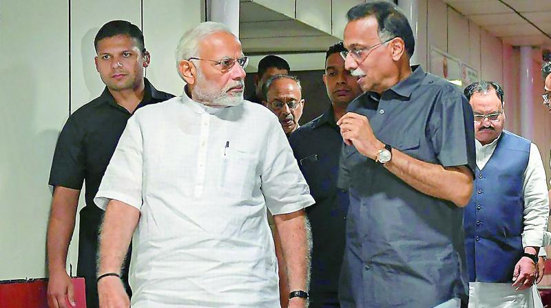 Prime Minister Narendra Modi talks to Ranjan Bhattacharya, the foster son-in-law of former prime minister Atal Behari Vajpayee, during his visit to AIIMS for a routine check-up, in New Delhi on Monday. (Photo: PTI)