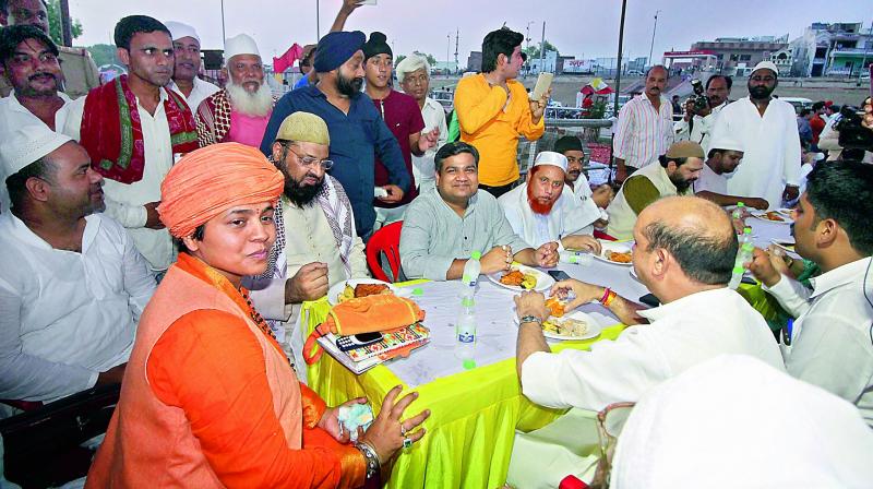 Muslims at an iftar party, organised by Mankameshwar Temple Mahant Diviya Giri, in Lucknow on Sunday. (Photo: PTI)
