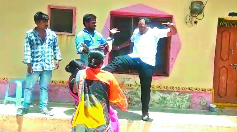 A screen grab of the video that went viral shows Dharpally Mandal Praja Parishad president Immadi Gopi kicking a woman (partially seen) in Nizamabad district.