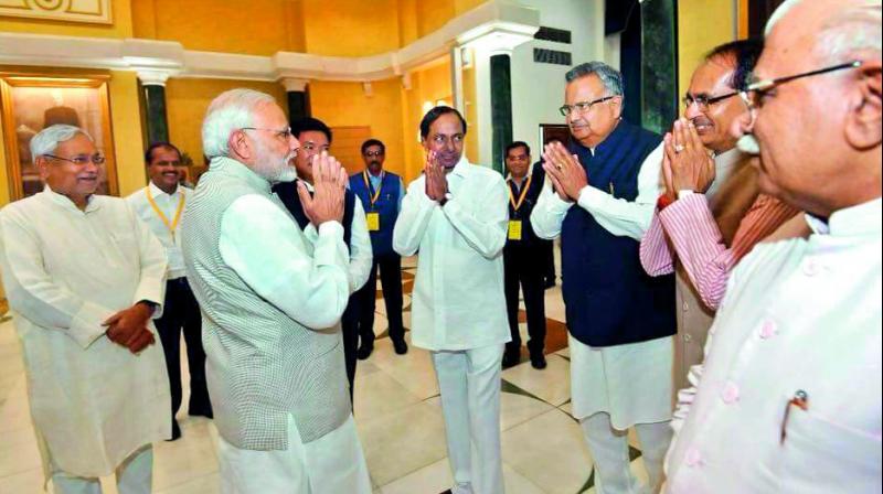 Prime Minister Narendra Modi is being greeted by Chief Ministers Shivraj Singh Chouhan of Madhya Pradesh (2nd from right), Raman Singh of Chhattisgarh (3rd right), and K. Chandrasekhar Rao of Telangana (4th right) as Nitish Kumar of Bihar (left) and Manohar Lal Khattar of Haryana (right) look on at a Niti Aayog meet in New Delhi on Sunday. (Photo: DC)