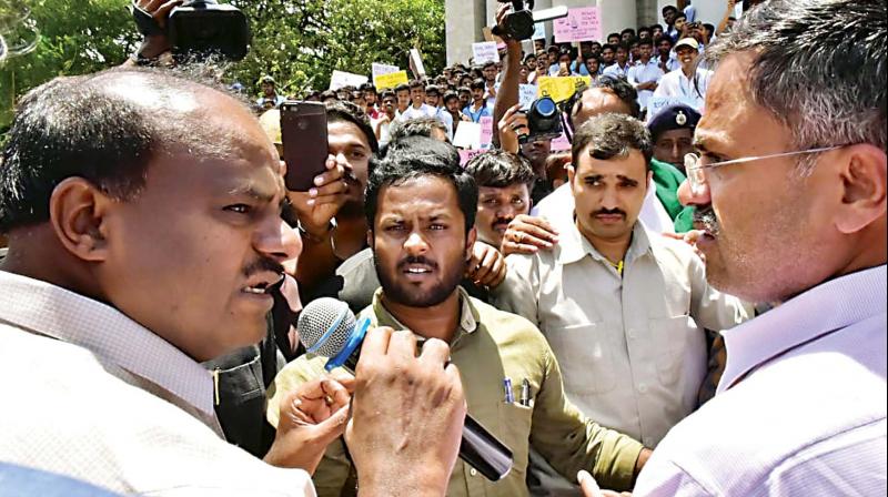 Chief Minister H.D. Kumaraswamy speaking to students and members of some farmers associations who were protesting against the privatisation of agriculture colleges in the state, in Bengaluru on Tuesday. (Photo: DC)