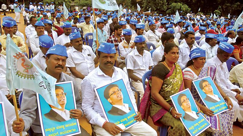 Supporters of Congress leader Satish Jarkiholi demanding a cabinet berth for him at a convention of Manava Bandutva Vedike in Bengaluru on Tuesday. (Photo: KPN)