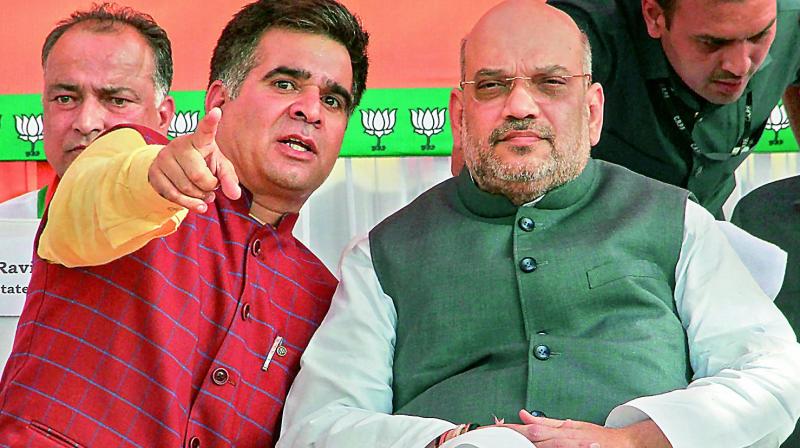 BJP national president Amit Shah with BJP state president Ravinder Raina during a public rally, in Jammu on Saturday. (Photo: PTI)