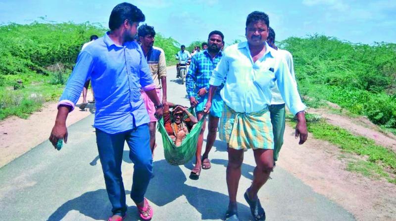 People carry one of the injured women from the accident spot in Vemulgonda on Sunday. (Photo: DC)