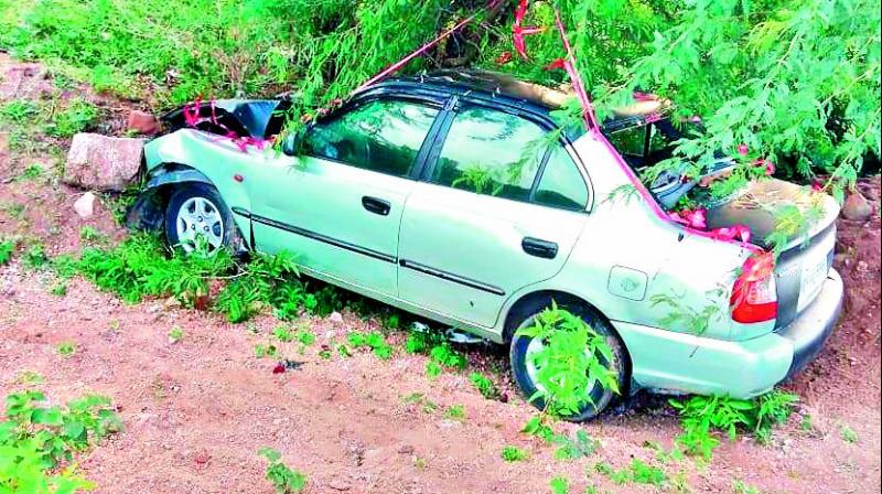 The car that was involved in the accident lies by the side of the road. (Photo: DC)
