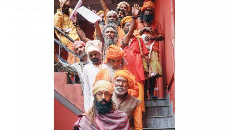 Sadhus wait in a queue to get themselves registered for Amarnath Yatra at a base camp, in Jammu. (Photo: PTI)