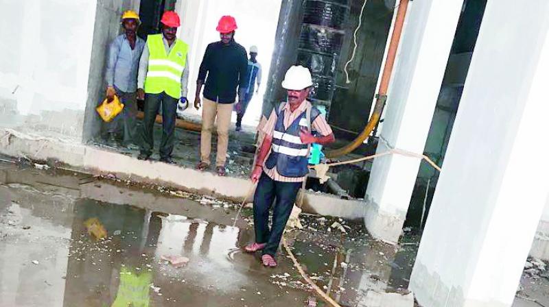 Stagnant water at a construction site next to Lahari Homes has become a breeding ground for dengue mosquitoes. (Photo: DC)