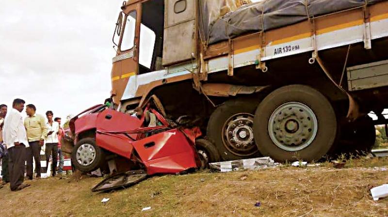 The car that was carrying five people from Bengaluru stuck under the lorry near Tumakuru on Wednesday. All the five died in the head-on collision. (Photo: DC)