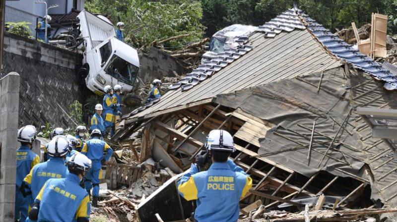Rescuers prepare to start a search mission for missing person at the site of a landslide in Kumano town in Hiroshima prefecture. (Photo: AP)