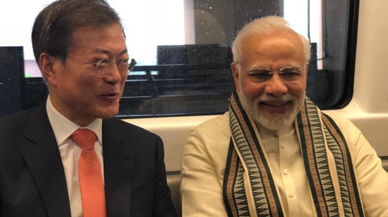 Prime Minister Narendra Modi with President Moon Jae-in, aboard the Delhi Metro, travelling to the inauguration of the mobile factory of Samsung in Noida. (Photo: ANI/Twitter)
