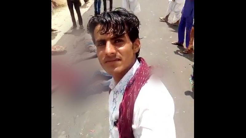 A picture of the incident showing an unidentified man clicking a selfie with one of the injured as his background. (Photo: ANI/Twitter)
