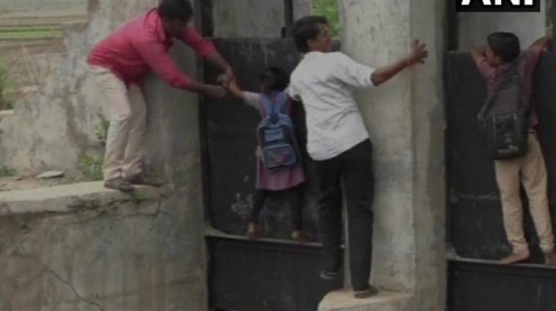 Children, too, cross the bridge by risking their lives on their way to school. (Photo: ANI)