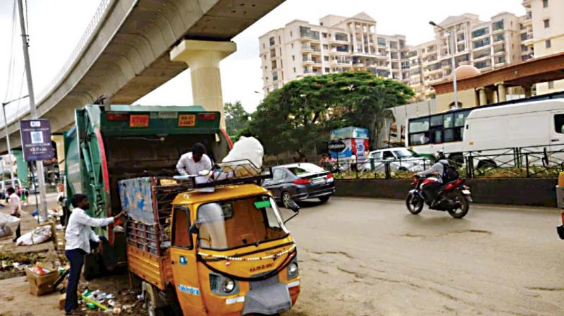 The space between Metro pillars 82 and 90 on the National Highway 209 in Yelachenahalli is being used as a garbage transit point and dump yard 	    (Image: DC)