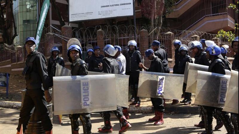 Police patrol outside the Zimbabwe Electoral Commission offices in Harare. (Photo: AP)