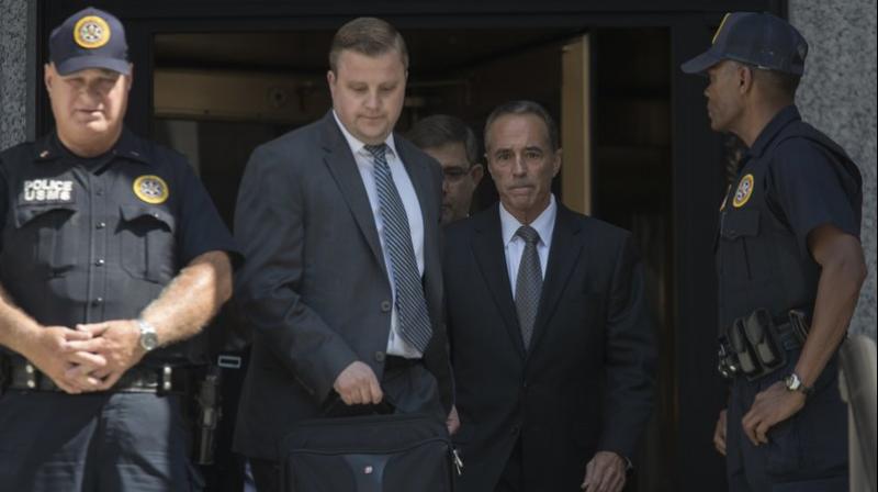 Republican US Rep. Christopher Collins (center) of western New York state has been indicted on charges that he used inside information about a biotechnology company to make illicit stock trades (Photo: AP)