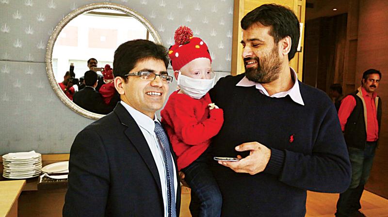 Zia Ulla holding his daughter Zeenia along with Dr. Sunil Bhat, Senior Consultant and Head of Pediatric Hematology, Oncology and Bone Marrow Transplantation service at Mazumdar-Shaw Cancer Center of Narayana Health City (Photo: DC)