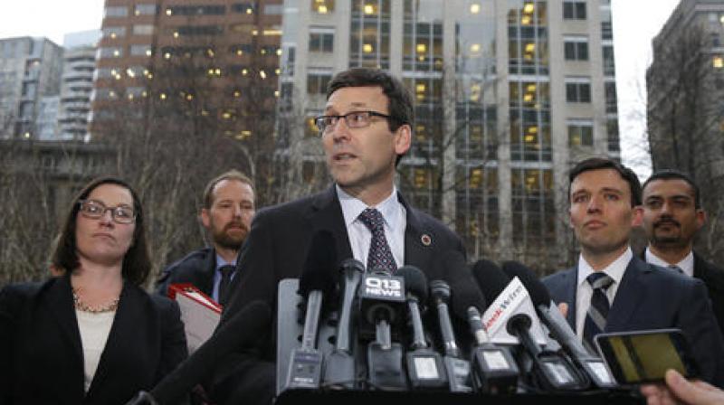 Washington Attorney General Bob Ferguson, center, talks to reporters as Solicitor General Noah Purcell, second from right, looks on, following a hearing in federal court in Seattle. (Photo: AP)