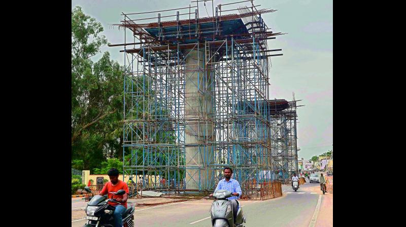 Kanakadurga flyover works in progress near K L Rao water works in Vijayawada on Tuesday. (Photo: DC)