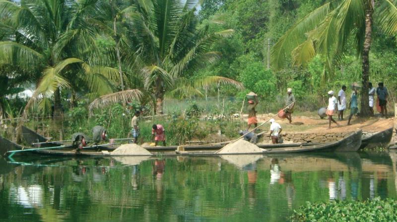 People work to pile up sand mined from the TS Canal to the shore. A scene from near Naaluchira (file pic)