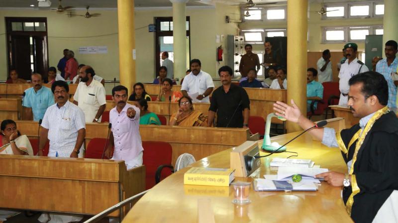 BJP councillors M.R. Gopan and Girikumar V.G. demand a detailed discussion on Tejaswini building issue at the council meeting in Thiruvananthapuram on Thursday.  (Photo: DC)