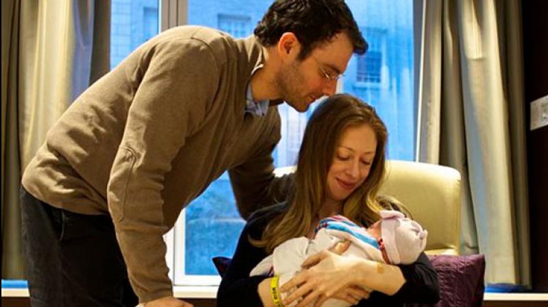 Chelsea Clinton and her husband Marc Mezvinsky with their daughter Charlotte Clinton Mezvinsky