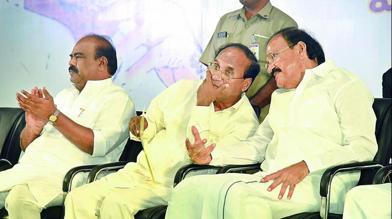 AP Speaker Kodela Siva Prasad Rao speaks with Vice-President elect M. Venkaiah Naidu while TS Speaker Madhusudhana Chary looks on at a function to release the Telugu translation of Mr Naidus speeches. (Photo: DC)