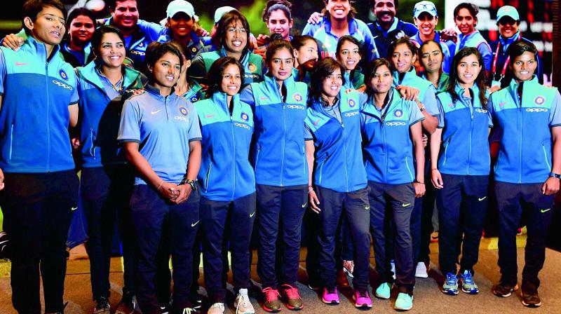 go girls: Members of the Indian womens cricket team are all smiles as they pose for a photo after arriving in Mumbai on Wednesday from London where they finished runners-up at the World Cup. (Photo: AP)