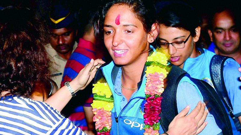 Indian womens cricket team vice-captain Harmanpreet Kaur is garlanded on her arrival in Mumbai early on Wednesday morning. (Photo: AP)