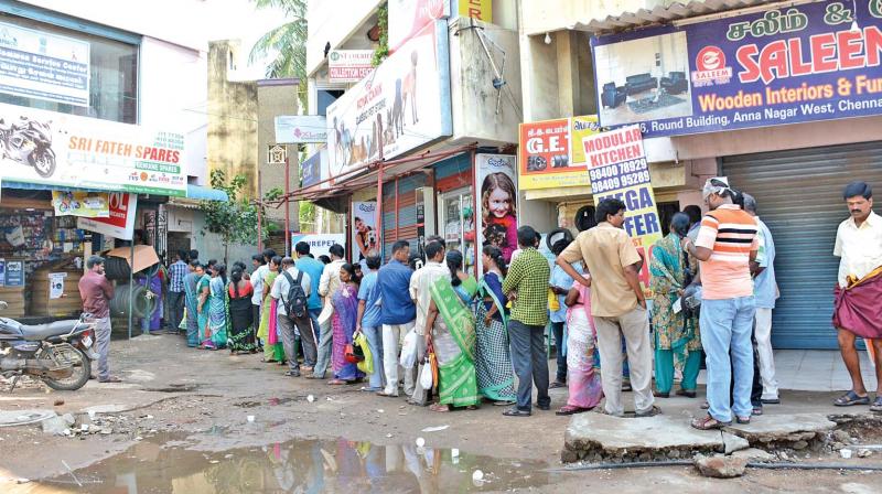 A huge crowd waits outside a Common Service Centre at Thirumangalam. (Photo: DC)
