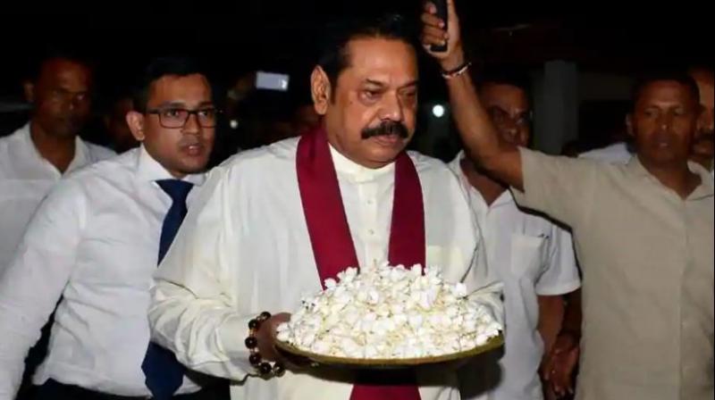 Sri Lankas former president and new prime minister Mahinda Rajapakse arrives at a temple after having been sworn in as prime minister in Colombo on October 26, 2018. (Photo: AFP)