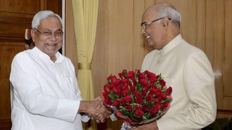Bihar Chief Minister Nitish Kumar greets Governor Ram Nath Kovind on being announced as NDAs presidential candidate, in Patna on Monday. (Photo: PTI)