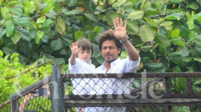 Shah Rukh Khan, with his son AbRam greets his fans gathered outside Mannat on the occasion of Eid. (Photo: Viral Bhayani)