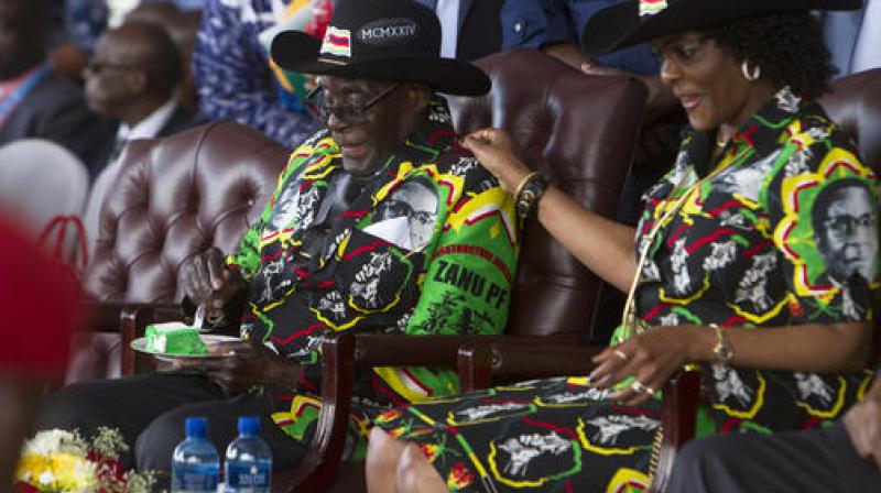 Zimbabwean President Robert Mugabe and his wife Grace, right, share a light moment during his 93rd Birthday celebrations in Matopos on the outskirts of Bulawayo. (Photo: AP)