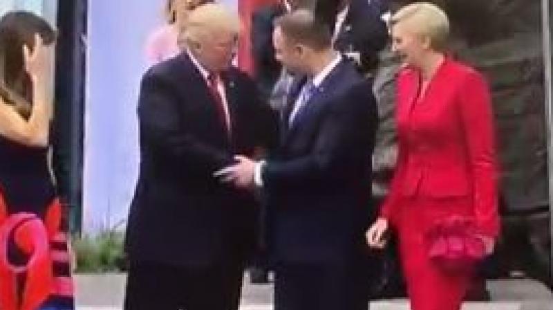 The US and Polands presidential couples were shaking hands Thursday before Trumps speech in front of a crowd in Poland. (Photo: Youtube grab)